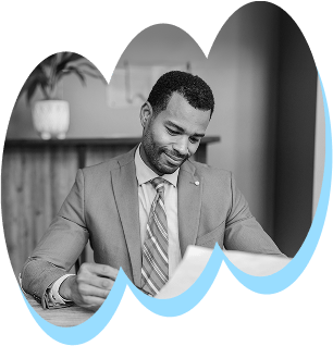 Black and white image of a man in a suit looking down at a document, with a light blue wavy border.