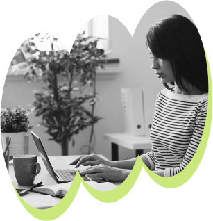 Black and white picture of a business owner working on a laptop