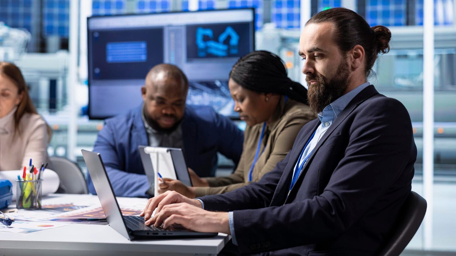 IT team working on laptops demonstrating insurance for technology professionals