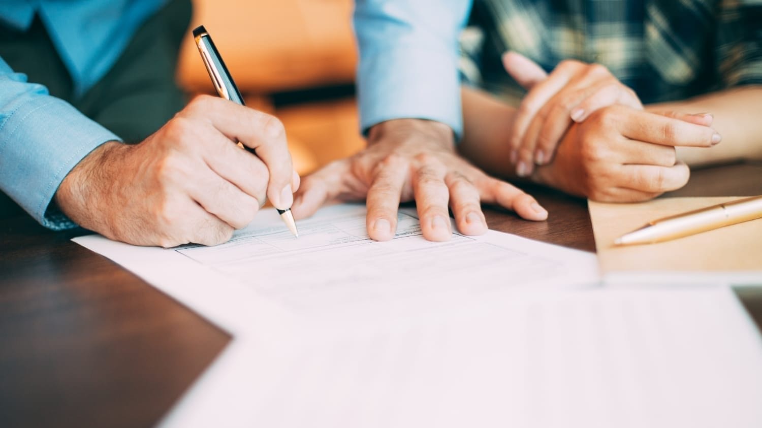 Signing paperwork for an errors and omissions insurance quote