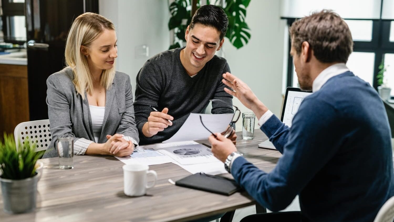 Startup business insurance meeting with advisor reviewing coverage documents