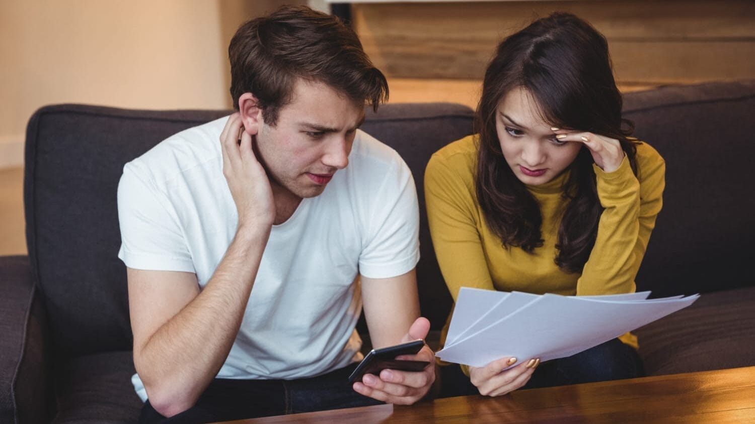 Couple analyzing policies for best errors and omissions insurance decisions
