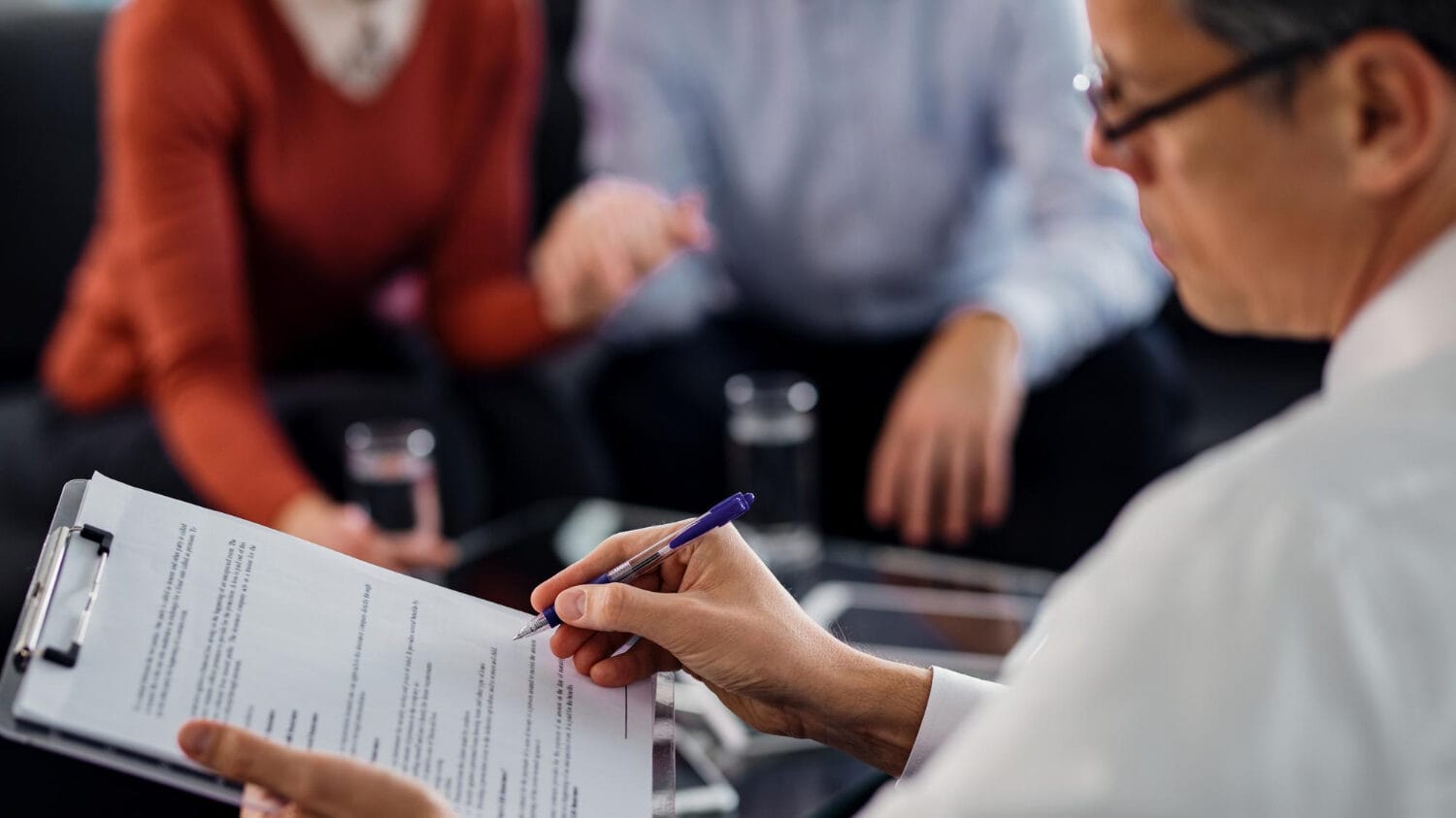 Insurance defense law firms reviewing client documents during case consultation