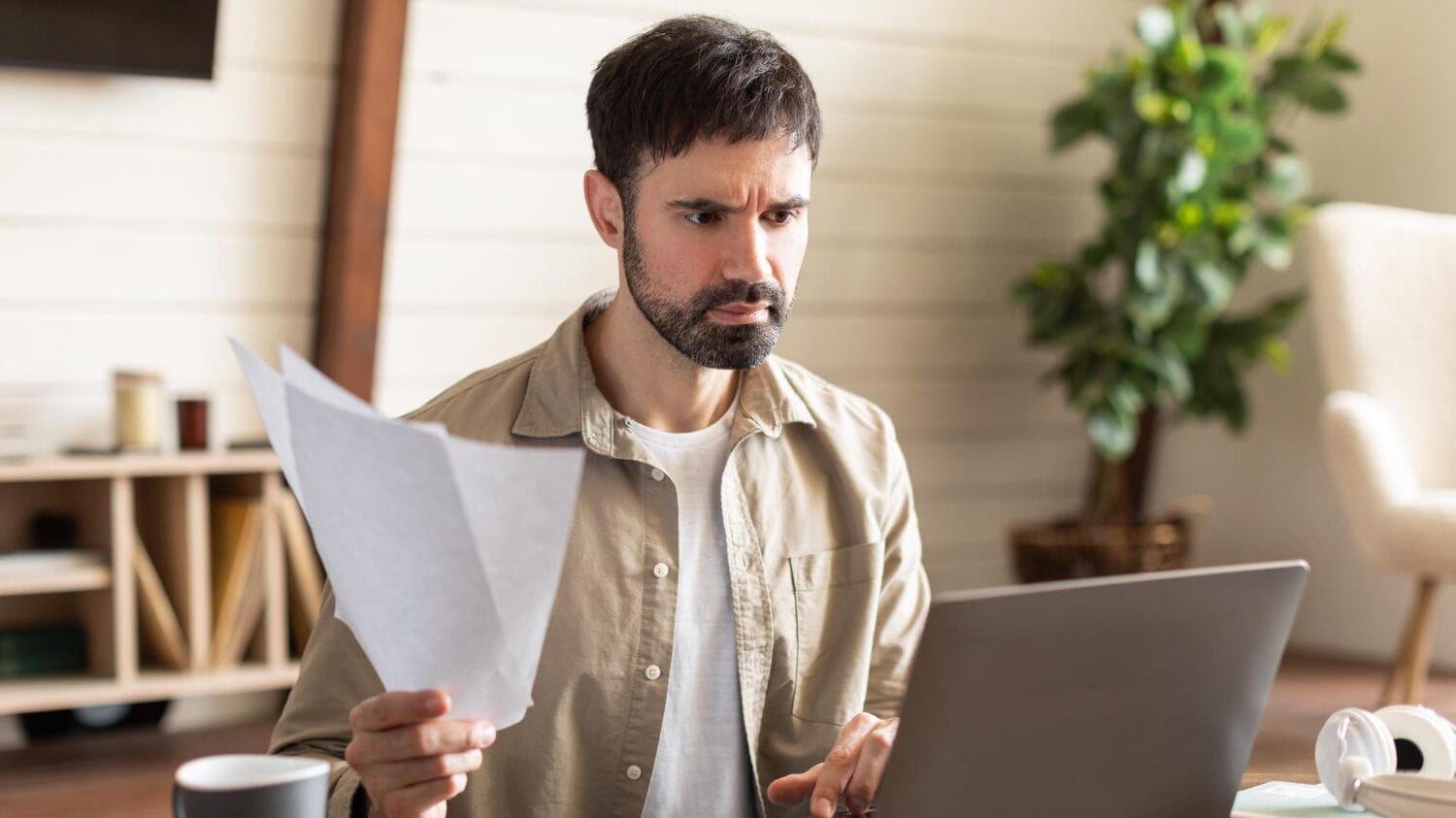 Business owner reviewing documents on technology services liability insurance