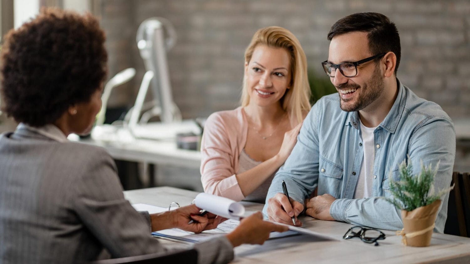 Commercial insurance quote meeting with clients reviewing coverage documents