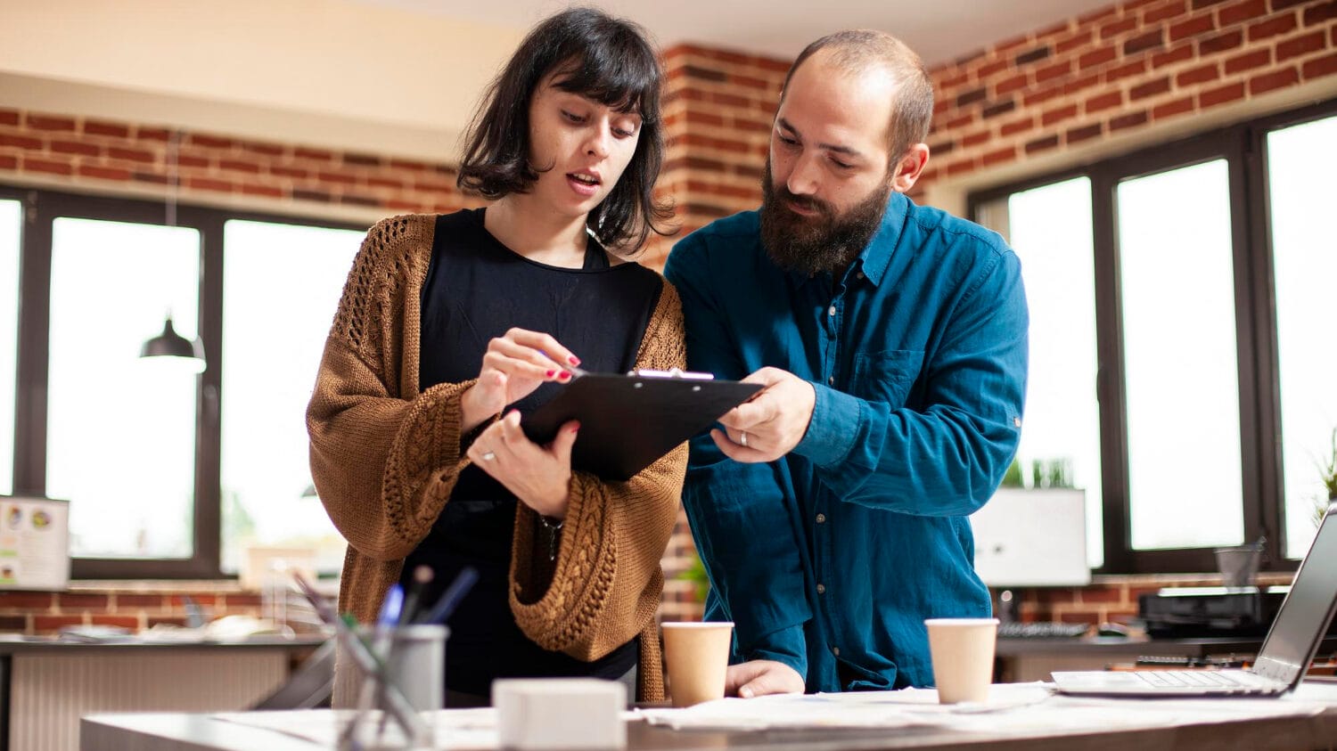 Business insurance for tech startups team reviewing plans in a modern office