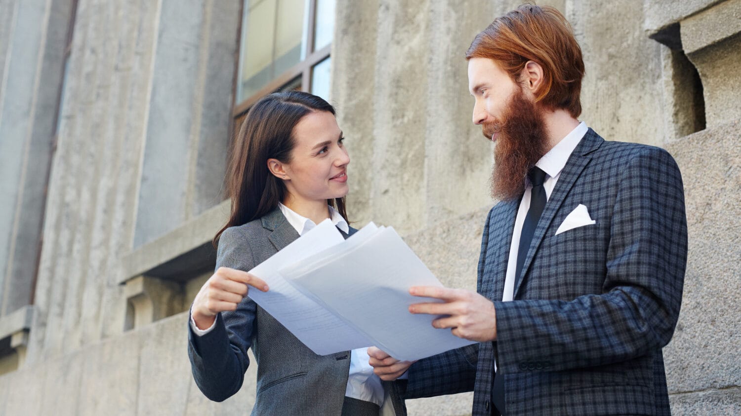 General vs professional liability insurance discussion between business professionals reviewing documents