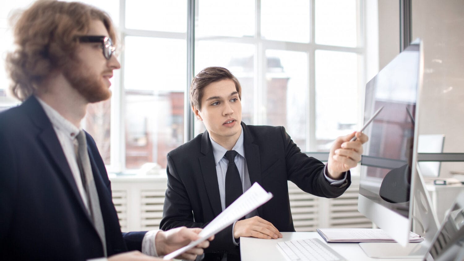 Is professional liability the same as errors and omissions meeting with professionals reviewing strategy on screen