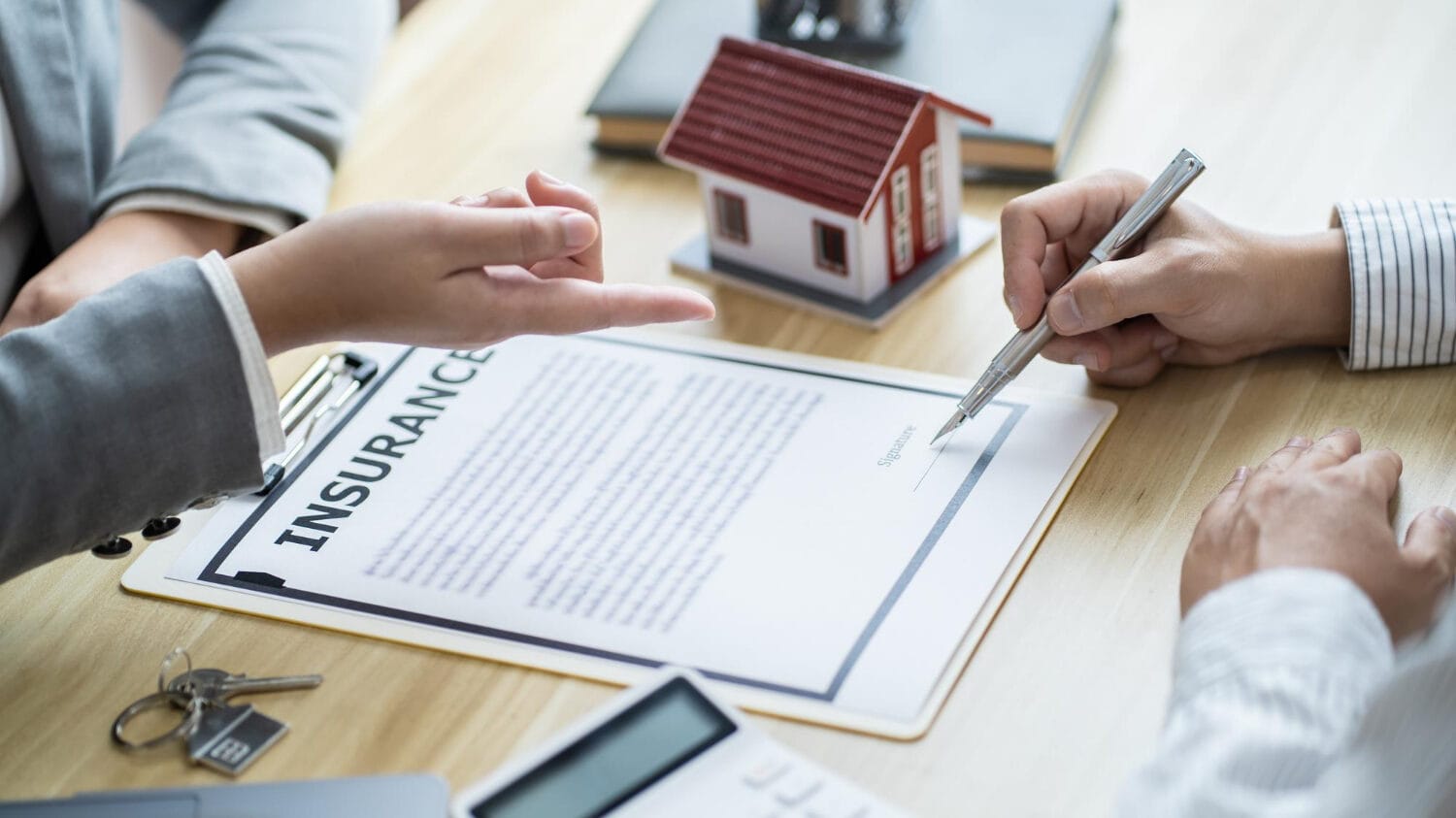 Business property insurance document signing with property model and coverage paperwork