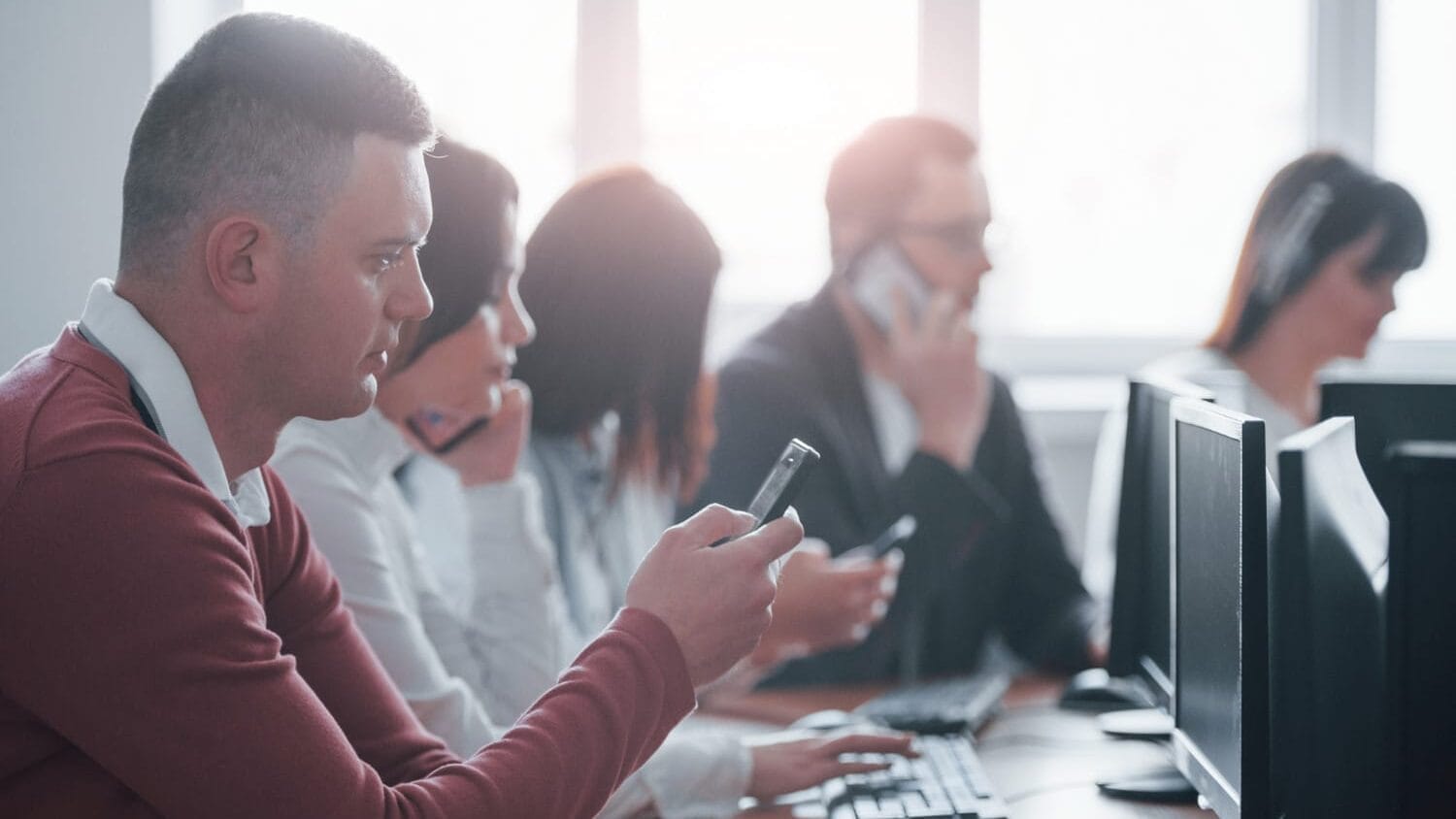 Office team managing risk with information technology liability insurance