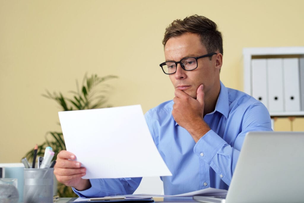 Entrepreneur evaluating policy documents and comparing business insurance for startups coverage options