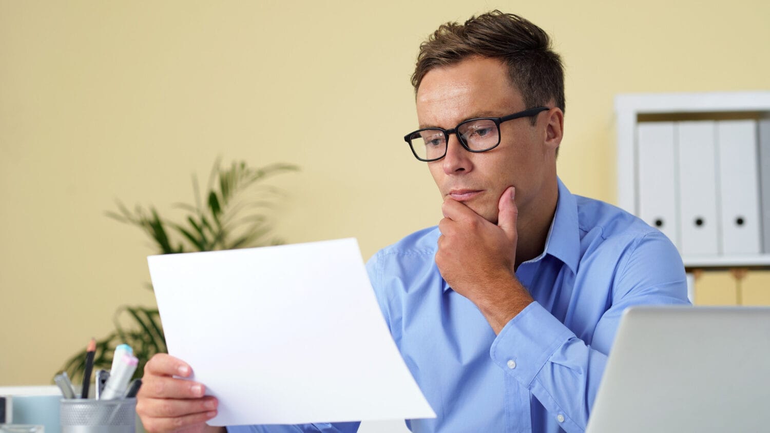 Office professional reading documents on liable definition and meaning