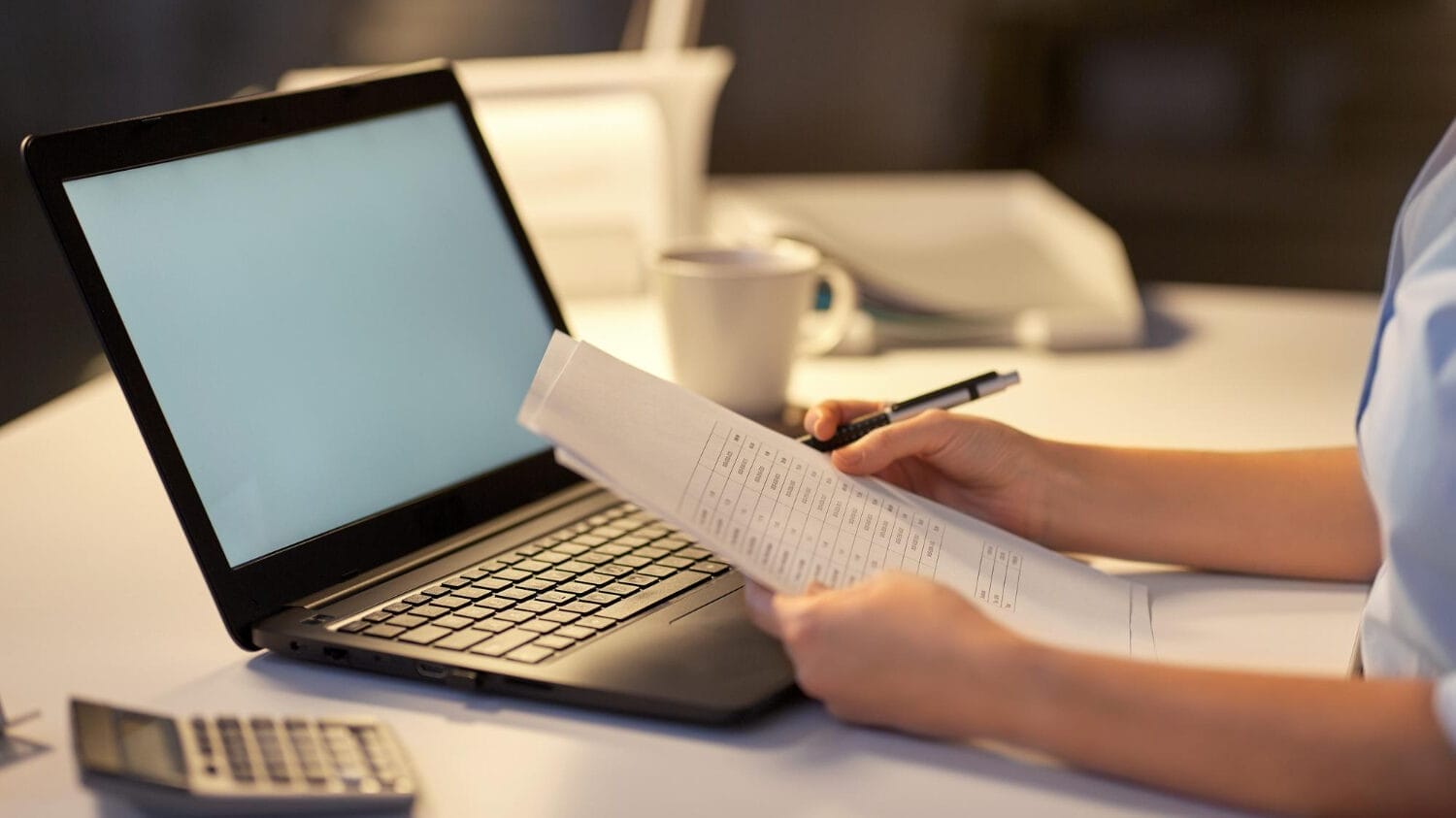 Office paperwork and laptop for technology services liability insurance