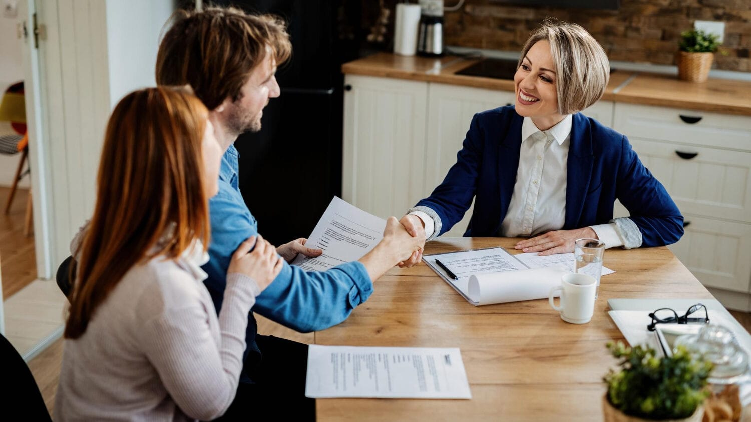 Commercial insurance quote discussion with advisor and clients at signing table