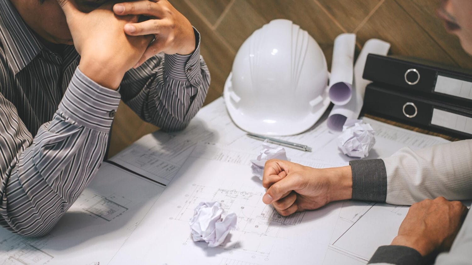 Project team discussing engineering errors and omissions insurance plans