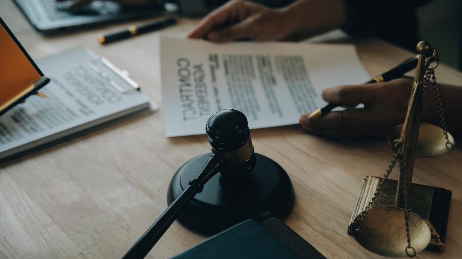Law firm insurance coverage documents with legal contract and gavel on desk