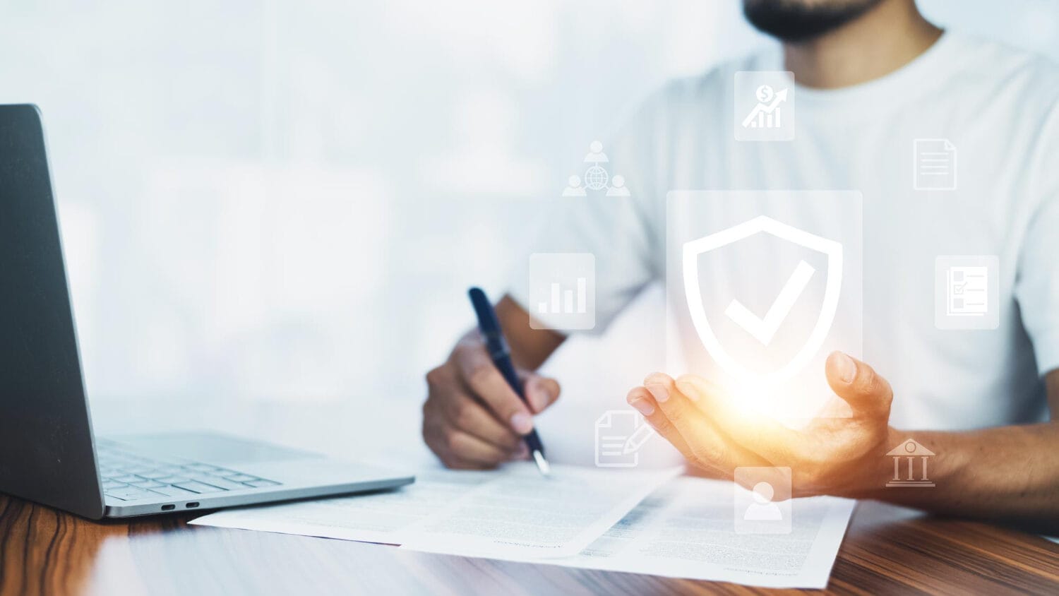 Cyber insurance policy protection reviewed with documents and laptop