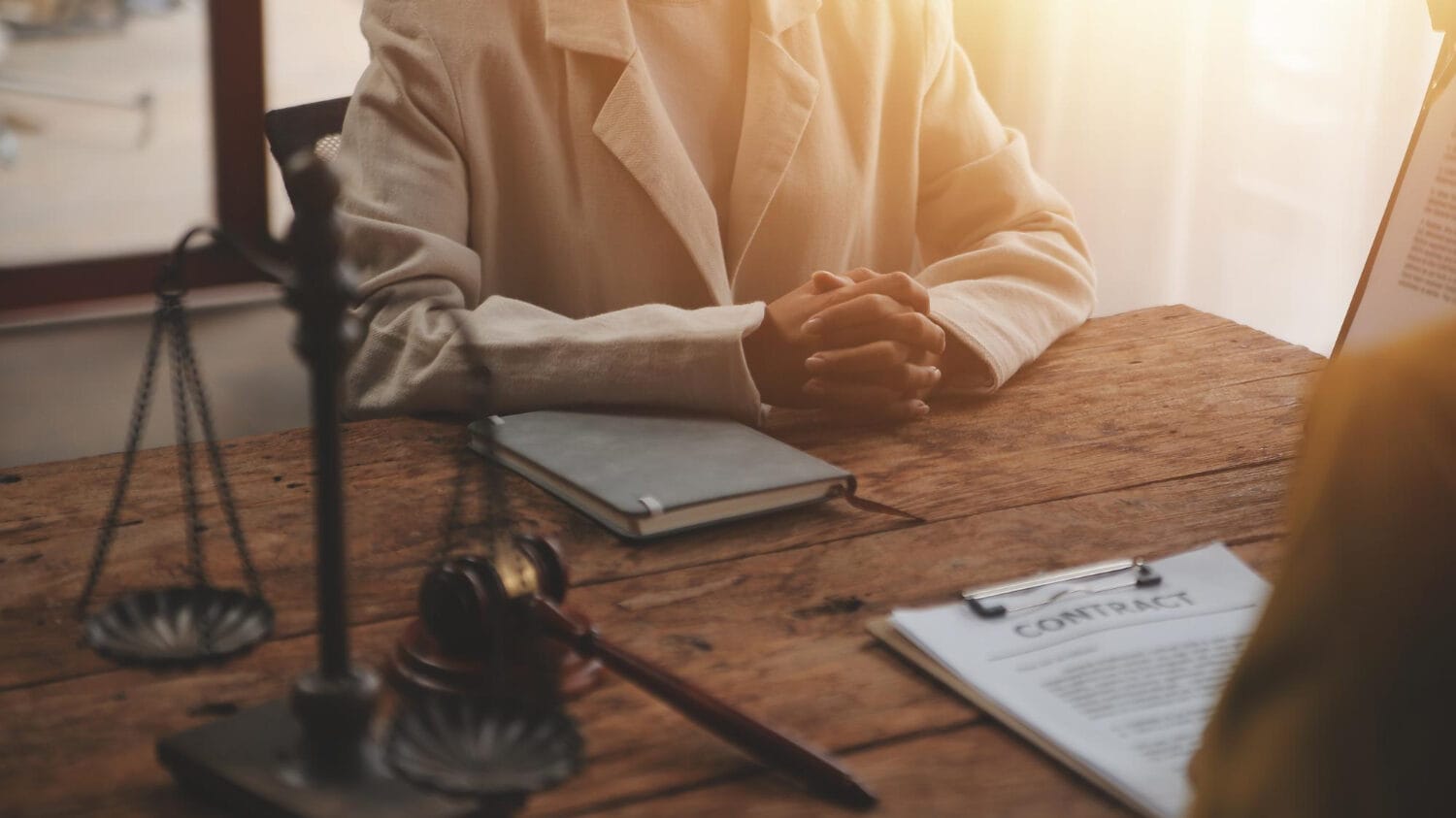 Law firm liability insurance consultation with legal contract on office desk