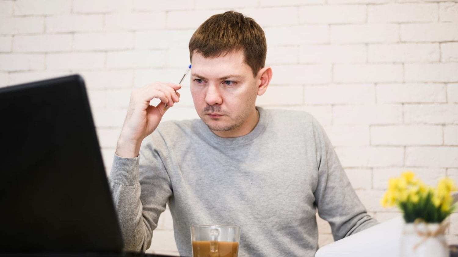 Man looking at a computer confused