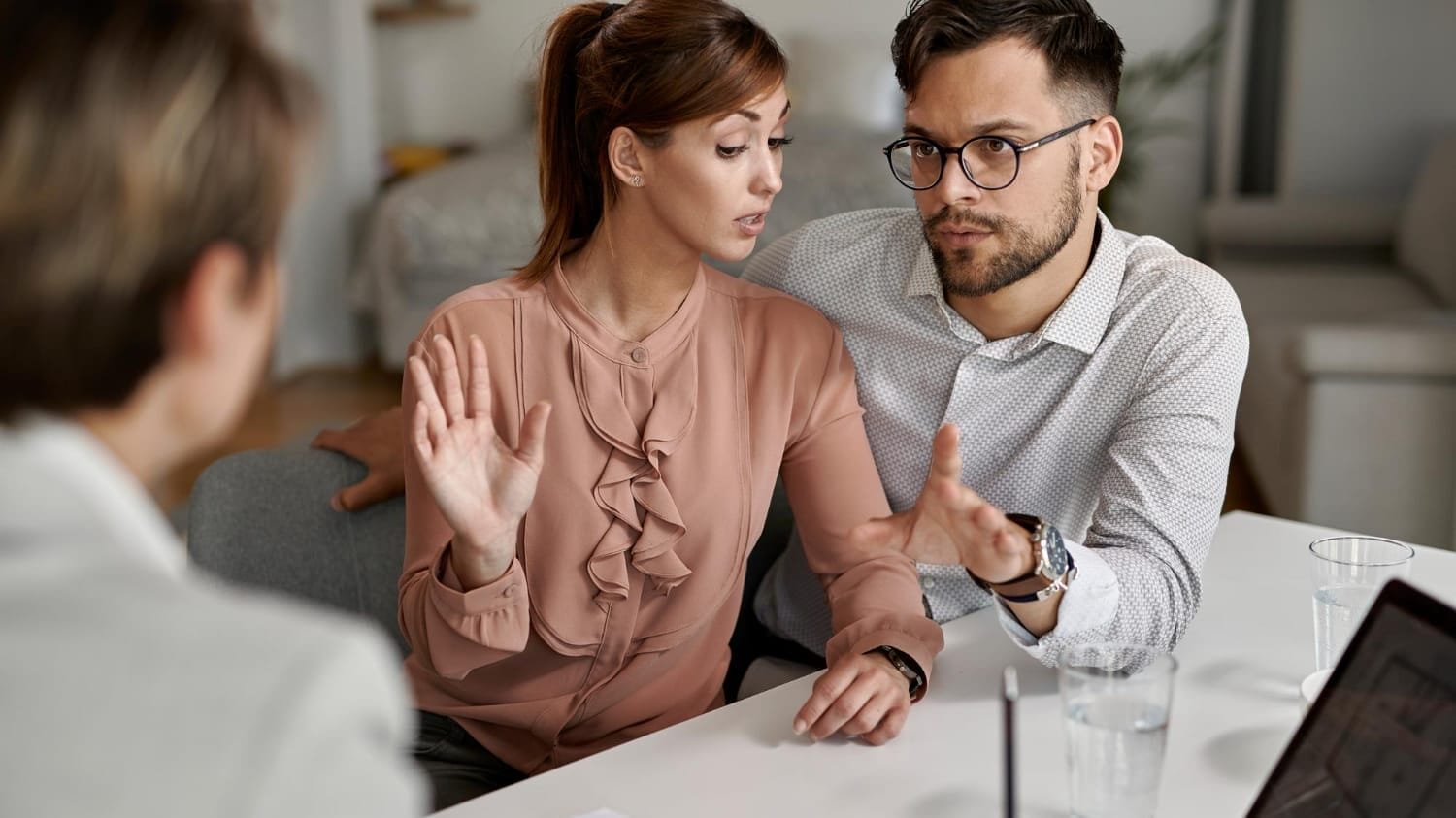 Clients discussing coverage concerns with advisor